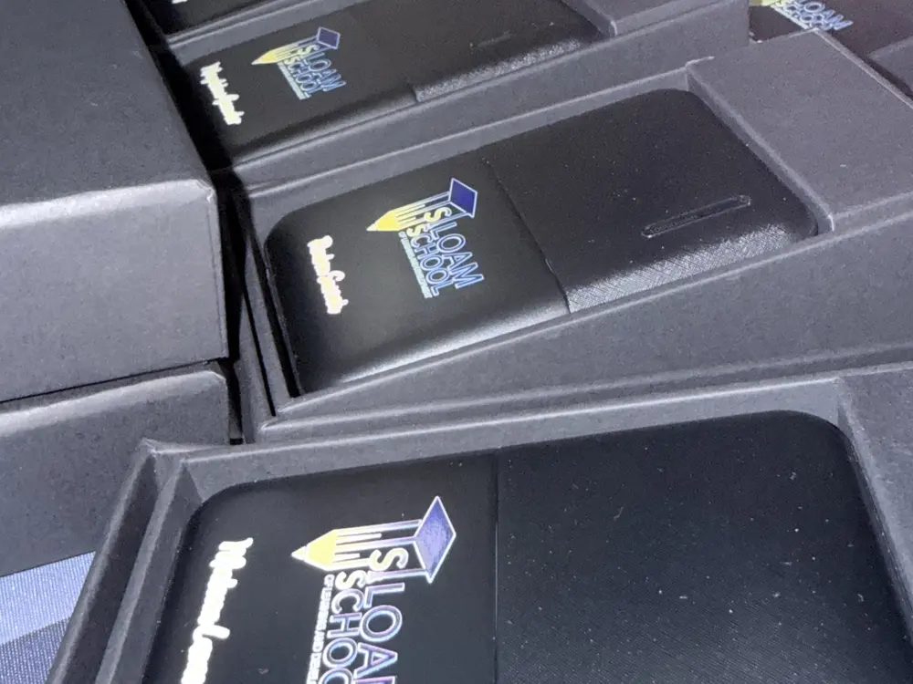 Power banks branded with a school logo